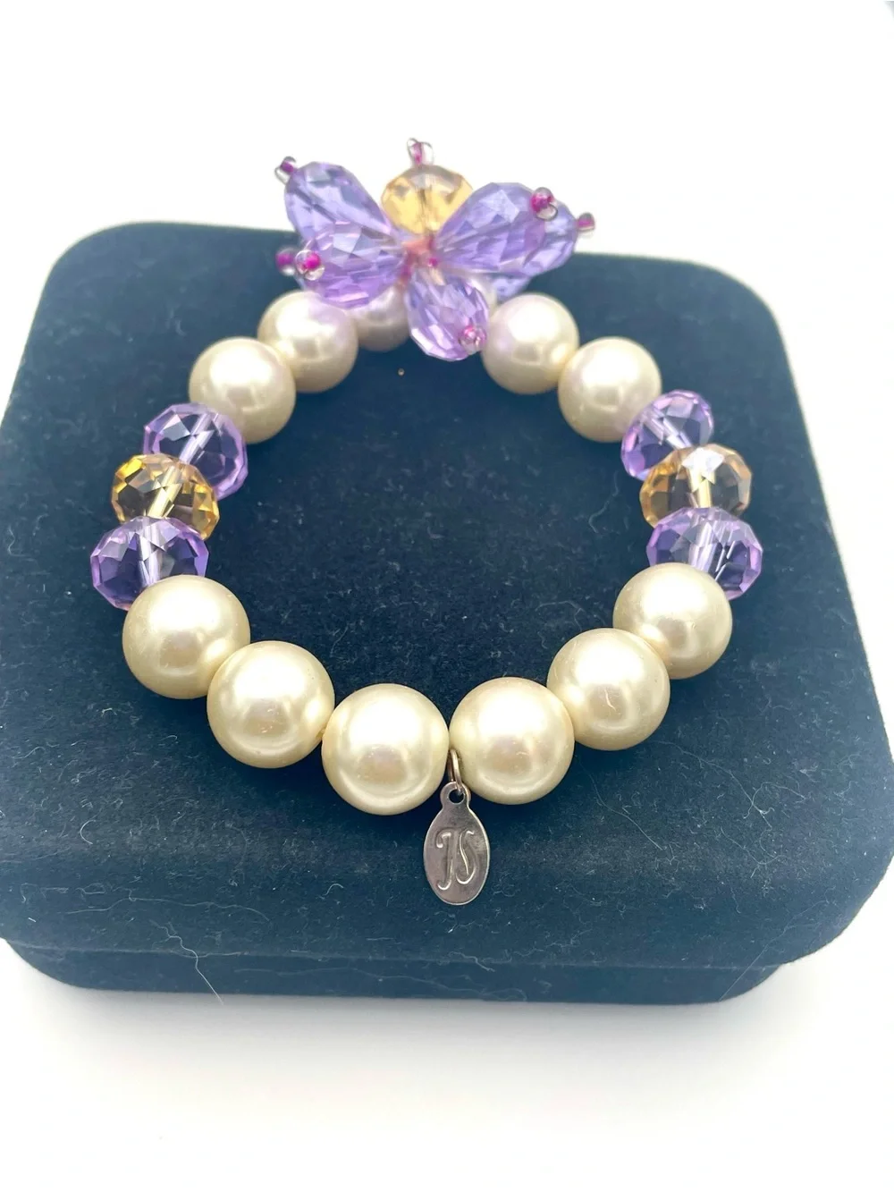 Jessica Simpson Pearl Stretch Bracelet with Purple Crystal Flower Charm. 8 inch